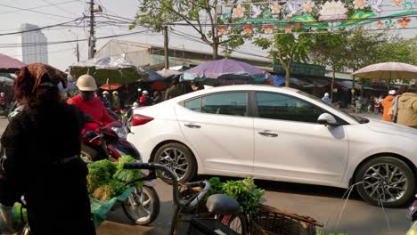 Static-shot-of-moped-drivers-stopping-and-looking-at-what-the-street-markets-are-selling