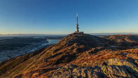 Dolly-shot-from-Mount-Ulriken-in-Bergen,-Norway,-showing-the-TV-tower-and-the-restaurant-at-the-summit-as-well-as-the-city-lying-below-the-mountain