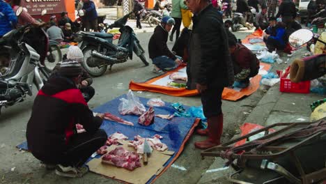 Static-shot-of-customers-looking-at-the-fresh-meat-on-sale-in-Lang-Son-Markets