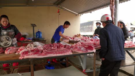 Static-shot-of-a-market-stall-selling-raw-meat-also-being-ground-up-in-Lang-Son