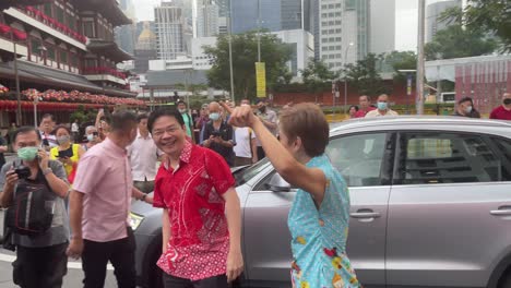 Singapore-Second-Minister-Josephine-Teo-welcomes-Lawrence-Wong,-the-Deputy-Prime-Minister-of-Singapore,-at-the-much-anticipated-Chinese-New-Year-Street-light-up-event-in-Singapore's-Chinatown