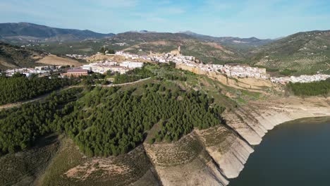 Iznajar-scenic-white-mountain-village-in-Andalusia,-Spain---Aerial-4k