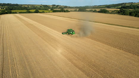 Establishing-Drone-Shot-of-Green-John-Deere-Combine-Harvester-Harvesting-on-Sunny-Summer-Day-Yorkshire-UK