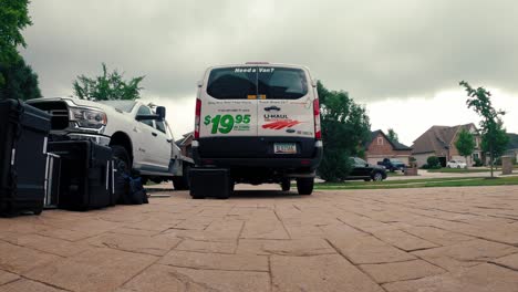 Zeitraffer-Eines-Filmteams,-Das-An-Einem-Bewölkten-Tag-Ausrüstung-In-Einen-Uhaul-Van-Lädt---Niedriger-Winkel