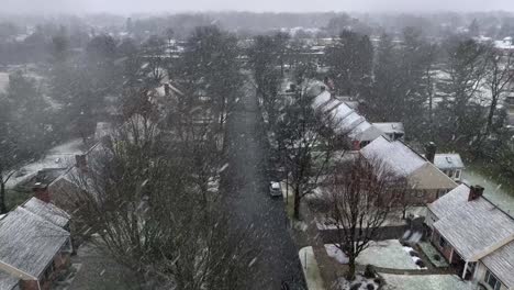 Aerial-dolly-forward-over-clean-neighborhood-street-on-snowy-winter-day