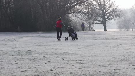 London,-England---January-22-2023:-Golfers-walking-along-a-frost-covered-golf-course-in-the-middle-winter