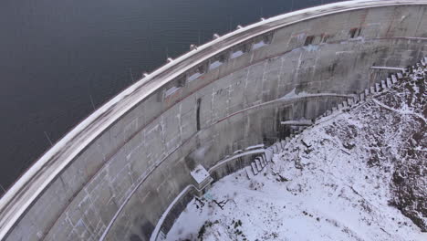 Aerial-top-view-of-a-dam-at-winter-time-in-Valea-Draganului,-Romania