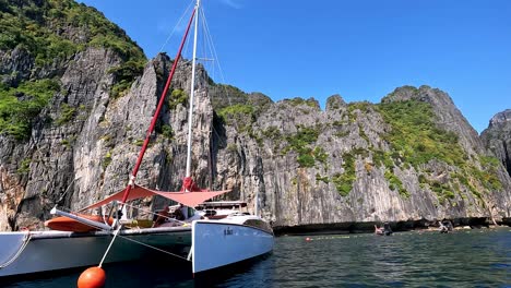 Sailing-Past-Moored-Catamaran-In-Maya-Bay-In-Thailand