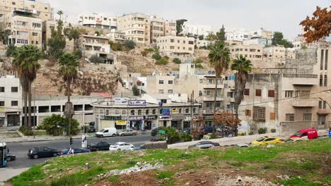 Cityscape-view-of-daily-life-in-capital-city-Amman-with-built-up-houses,-apartments,-shops-and-traffic-in-Jordan,-Middle-East