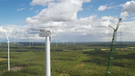 Construction-process-of-a-wind-turbine-with-the-tower-and-the-hub-installed,-drone-landscape