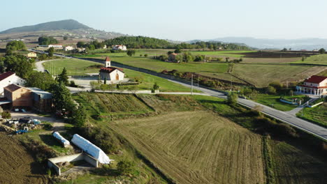 Wide-aerial-shot-of-a-small-black-car-driving-through-Molise-region-in-Italy