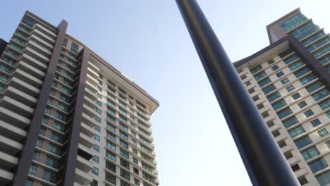 Looking-Up-At-Street-Light-Pole-With-Emaar-Residential-Apartments-Located-In-Crescent-Bay,-Karachi