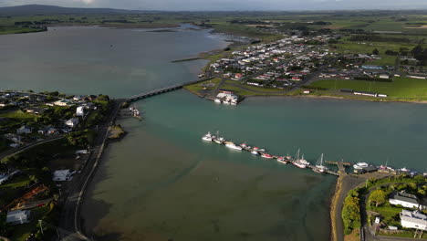 Small-township-of-Riverton-with-bridge-in-New-Zealand,-aerial-drone-view