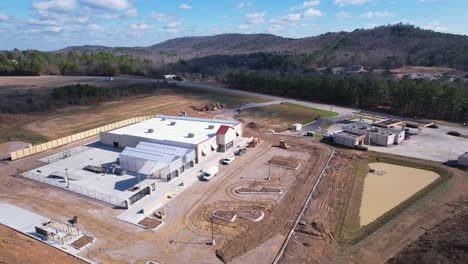 Aerial-pass-by-of-newly-constructed-Tractor-Supply-storefront-in-Pelham,-Alabama-revealing-surrounding-commercial-zones