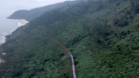 Drone-flying-over-train-alongside-coast-of-Vietnam