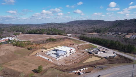 Aerial-high-altitude-approach-of-newly-constructed-Tractor-Supply-storefront-in-Pelham,-Alabama