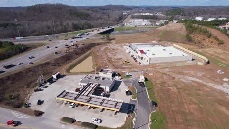 Aerial-orbital-of-newly-constructed-Tractor-Supply-storefront-in-Pelham,-Alabama-alongside-Interstate-65