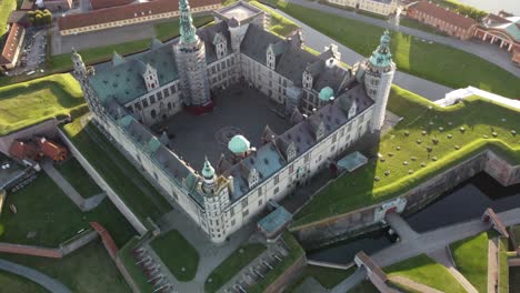 aerial-drone-view-of-kronborg-castle-which-is-located-in-denmark-near-copenhagen,-it-is-in-front-of-sweden-across-the-north-sea