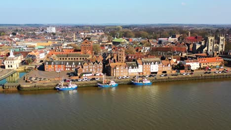 Aerial-view-of-Kings-Lynn-riverside,-trawlers-and-the-River-Great-Ouse,-Kings-Lynn,-Norfolk,-UK