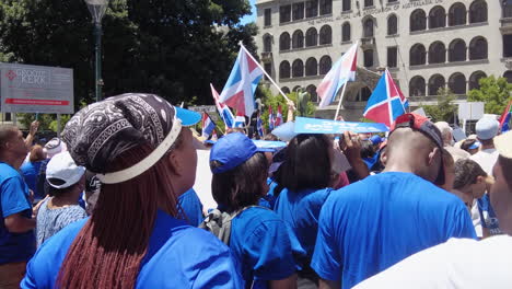 Democratic-Alliance-and-Cape-Exit-members-listen-to-a-political-speech-while-waving-party-flags