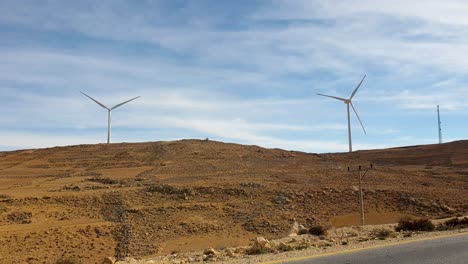 Wind-turbine-farm-producing-green,-clean-energy-in-vast-remote-desert-landscape-in-Jordan,-Middle-East