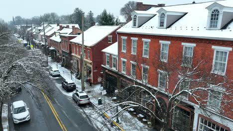 Low-aerial-of-snow-covered-buildings-in-small-town-in-America
