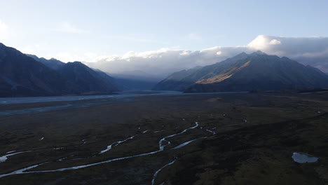 Mount-Cook-and-neighboring-mountains-during-sunset-overlooking-the-valley-and-flowing-rivers