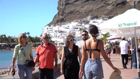 Woman-rear-view-walk-through-streets-of-white-town-old-city-in-Callao-Beach,-Gran-Canaria,-canary-islands,-Spain