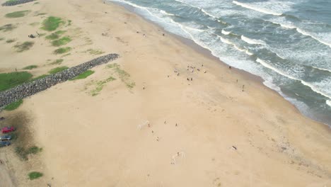 Luftaufnahme-Einer-Stadt-Von-Fischern,-Die-Am-Strand-Von-Chennai-Spielen