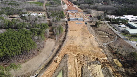 Drone-shot-of-large-highway-construction,-540-Beltline-North-Carolina,-focusing-on-overpass-construction
