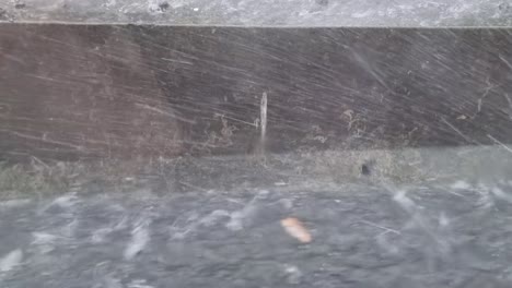 Heavy-rain,-hail-and-flooding-while-parked-on-side-of-Auckland-highway-looking-down-at-the-gutter