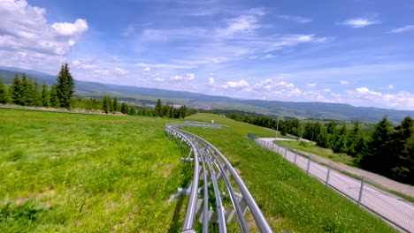 Alpine-coaster-ride-downhill,-Toplita-Romania