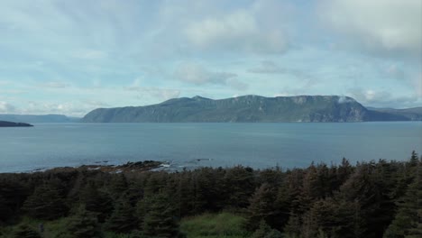 Gros-Morne-National-Park,-Newfoundland---Push-In-Drone-clip-with-the-mountain-and-ocean-in-the-foreground