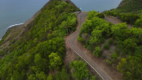 Aerial-approach-and-tilt-up-towards-people-with-Jeep-pulled-into-lookout-in-Halawa-Valley-in-Molokai,-Hawaii