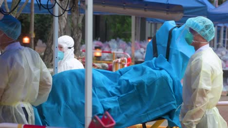 Health-workers-carry-a-stretcher-outside-a-residential-building-placed-under-lockdown-after-a-large-number-of-residents-tested-positive-in-Hong-Kong