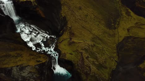 Aerial-drone-view-over-water-flowing-down-Ófærufoss-waterfall,-in-Iceland-highlands