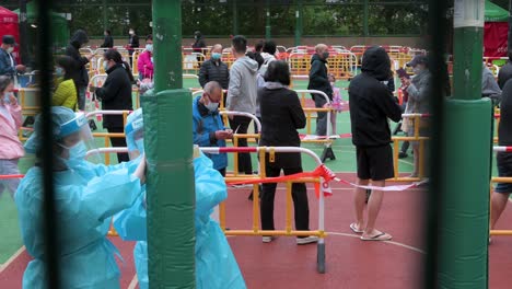 Chinese-residents-wait-in-line-to-go-through-a-Covid-19-Coronavirus-testing-as-a-public-housing-complex-is-placed-under-lockdown-after-a-large-number-of-residents-tested-positive