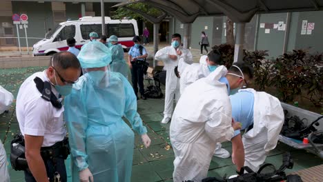 Police-officers-wear-personal-protective-equipment-outside-a-public-housing-building-complex-placed-under-lockdown-after-a-large-number-of-residents-tested-positive