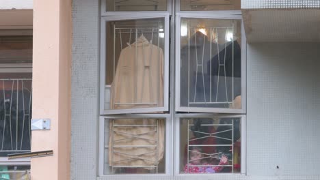 A-young-resident-looks-out-of-the-window-as-the-building-is-under-lockdown-at-a-public-housing-complex-after-a-large-number-of-residents-tested-positive-in-Hong-Kong