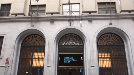 facade-of-old-B3-Bovespa-stock-exchange-building,-with-company-logo-and-flags