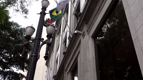 facade-of-old-B3-Bovespa-stock-exchange-building,-with-company-logo-and-flags