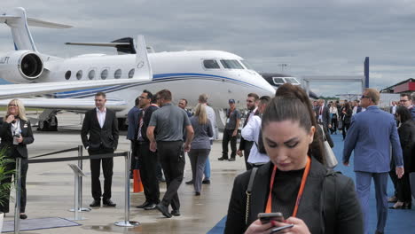 Gulfstream-planes-during-EBACE-exhibition-in-Geneva,-people-passing-by