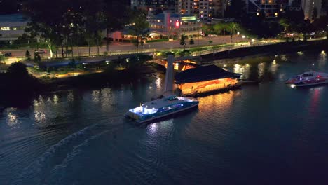 Aerial-view-of-Brisbane-City-Ferry-"CityCat"-Arriving-at-"Regatta"-terminal-in-Toowong-after-sunset