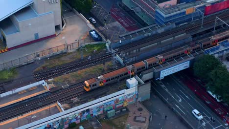 Aerial-view-of-Train-Arriving-At-The-South-Brisbane-Station-near-South-Bank,-Brisbane-City,-Queensland,-Australia