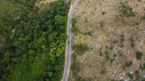 Drone-shot-following-rented-car-on-the-rural-road-in-Korfu-Island,-Greece