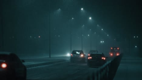 Cars-driving-away,-leaving-the-city-on-a-frosty-winter-night-during-a-blizzard