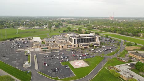Beaumont-hospital-center-surrounded-by-green-flat-landscape,-aerial-drone-view