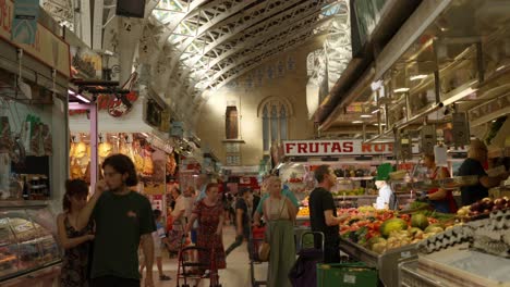 People-shopping-for-groceries-at-Famous-old-Central-Valencia-Marketplace-in-Spain,-Europe