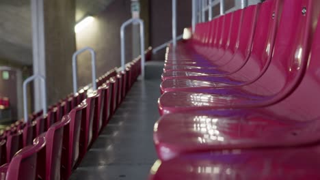 Empty-red-color-seat-row-in-massive-arena,-motion-view