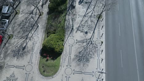 aerial-top-down-cinematic-view-of-portuguese-sidewalk-or-cobblestones-along-of-liberty-avenue-in-Lisbon
